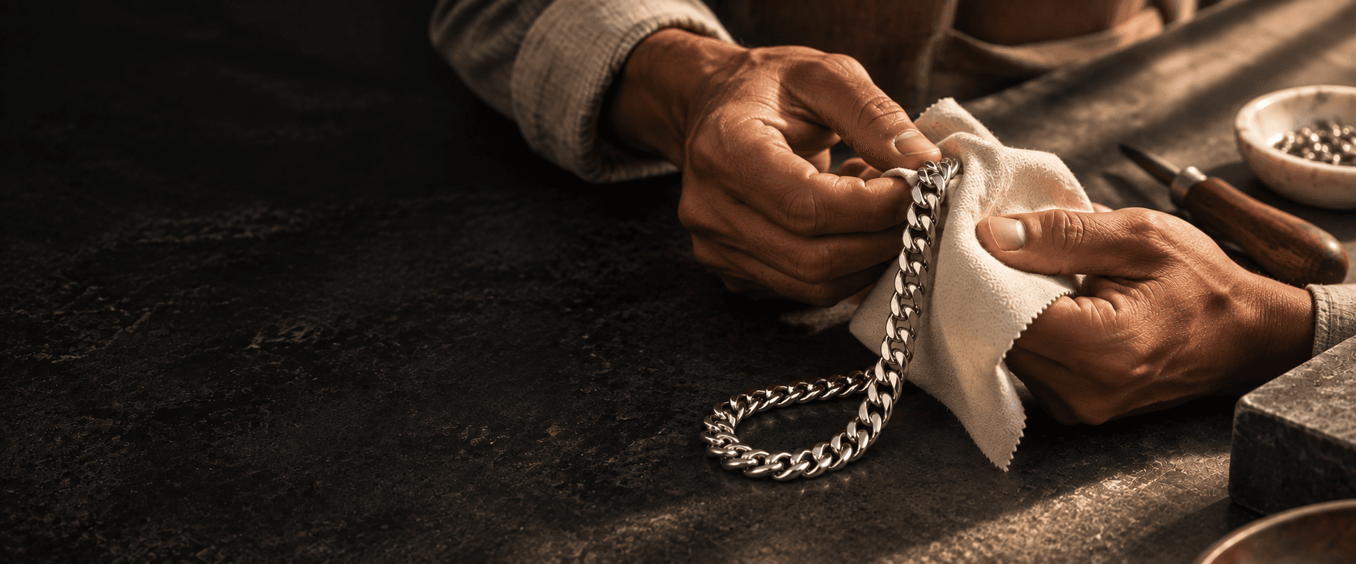 An artisan hand-polishing a sterling silver curb chain