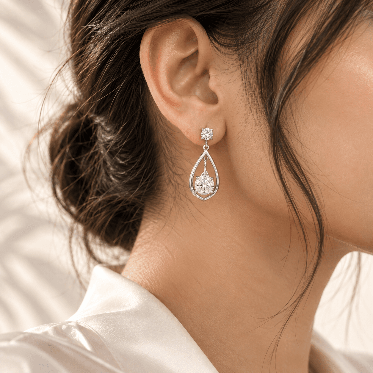 Sterling silver drop earring worn with a low bun